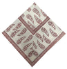 Beige napkin with red pattern on a white background