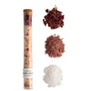 Spa product with a tube and various bath salts on a light gray background