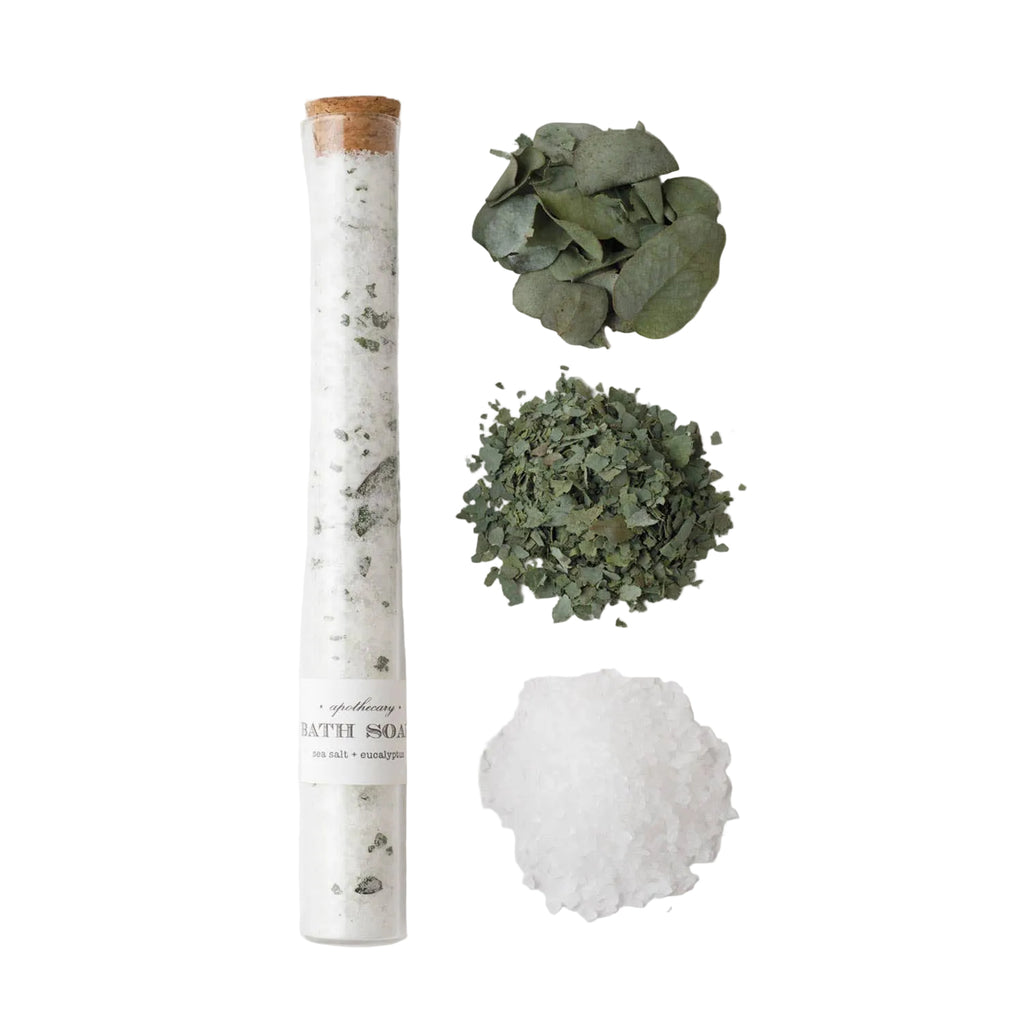 Bath salt tube with eucalyptus leaves on a white background