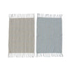 Two woven towels with fringe on a white background