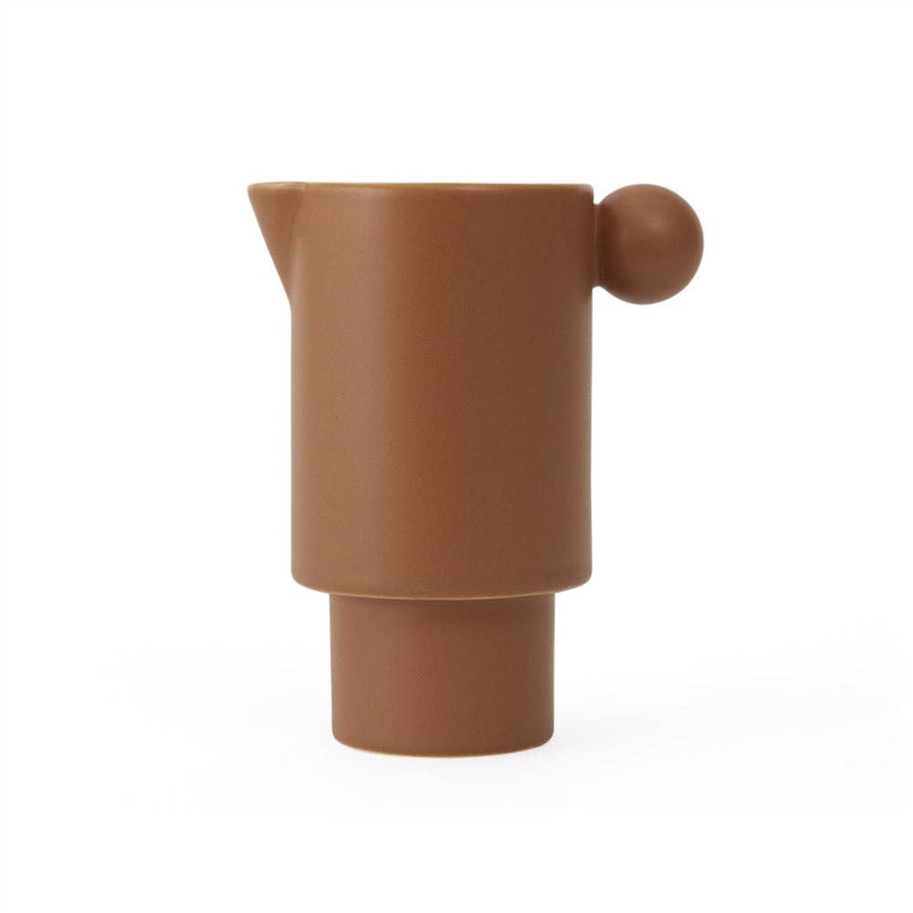 Brown ceramic pitcher on a white background