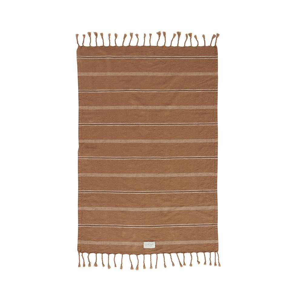Brown striped towel with tassels on a white background