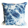 Decorative pillow with blue and white tie-dye pattern on a white background