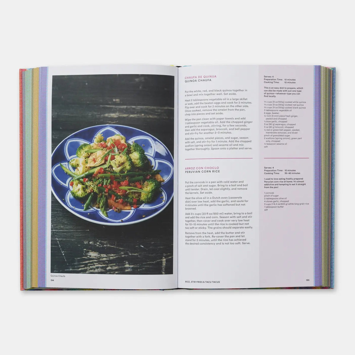 An open printed cookbook or recipe book spread, showing a plated green salad on the left page and recipe text on the right page, photographed against a light gray background.