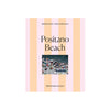 Piecework Puzzle Co. Positano Beach puzzle packaging with striped design and photo of beach scene.