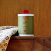 Raazi Tea canister on a wooden surface with a floral cloth in the background