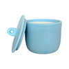 Blue ceramic candle with a matching lid on a white background