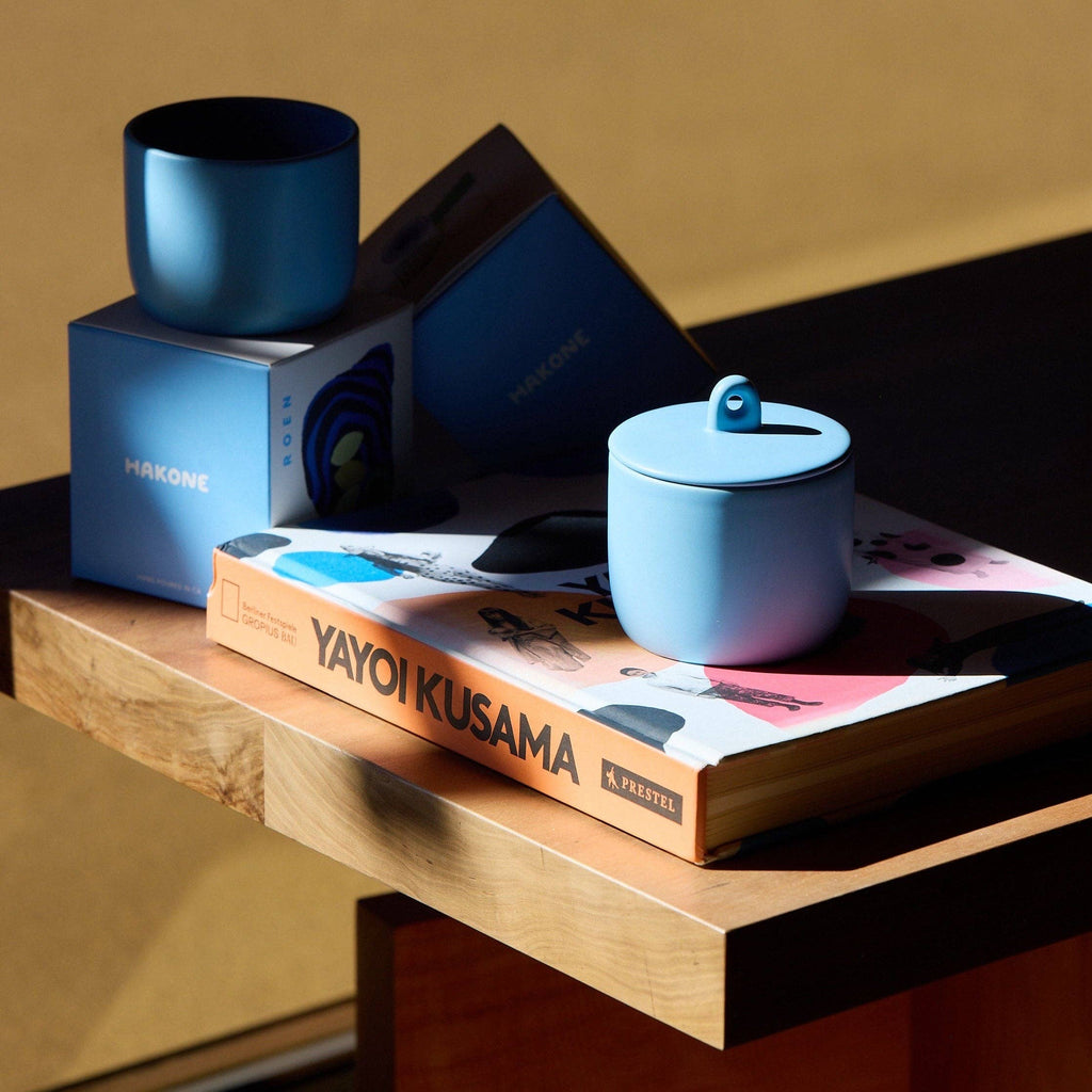 Blue ceramic container on a book with a blurred background