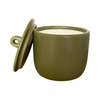 Green ceramic vessel with a candle inside on a white background