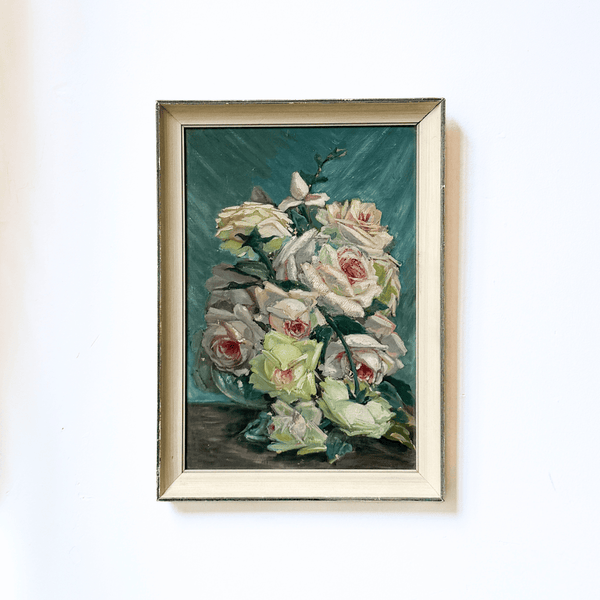 Framed painting of flowers on a white wall