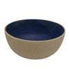 Ceramic bowl with blue interior and beige exterior on a white background