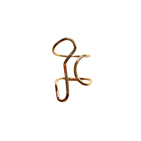 A gold-plated abstract wire ring with a minimalist, fluid design, shown on a plain white background.