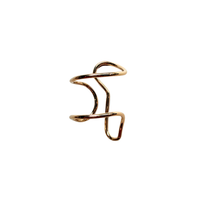 A gold-colored abstract wire ring with a twisted, organic loop design, shown on a plain white background.