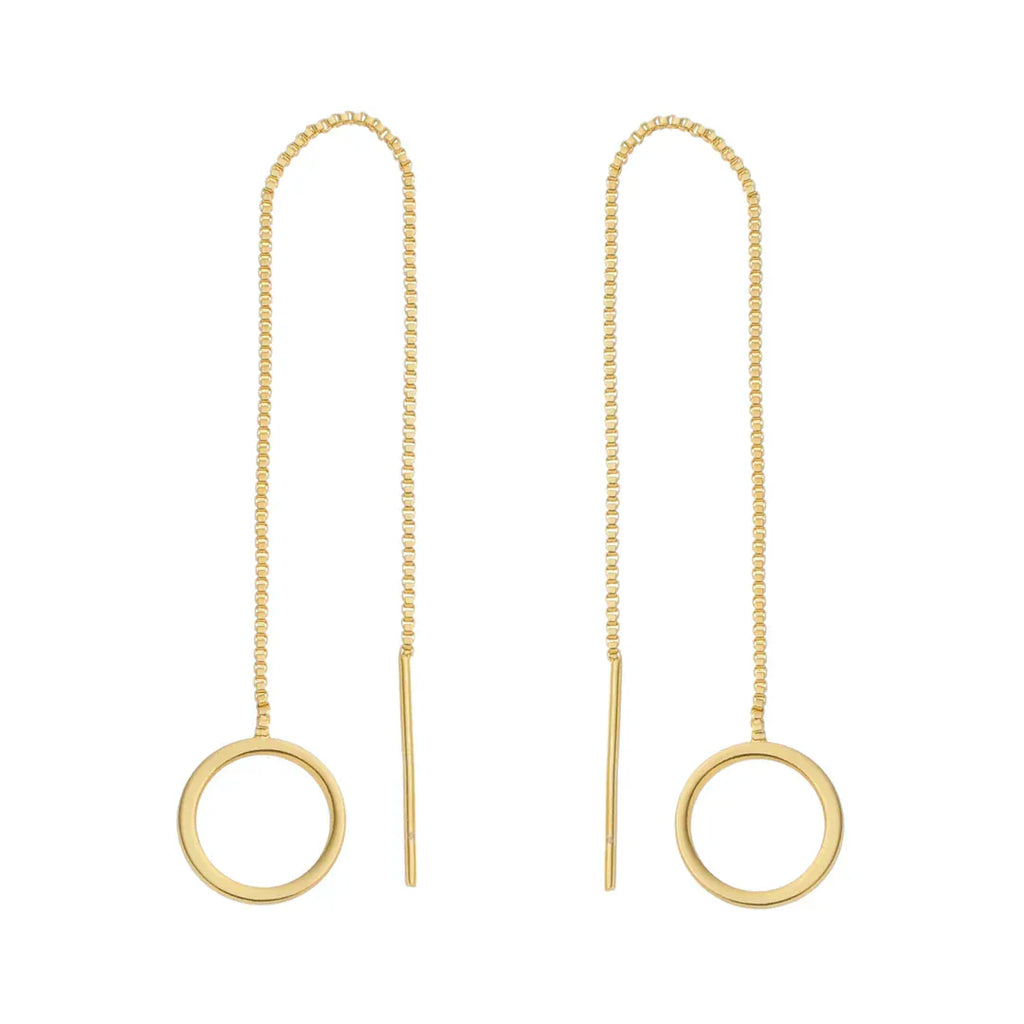 Gold earrings with circular ends on thin chains against a white background
