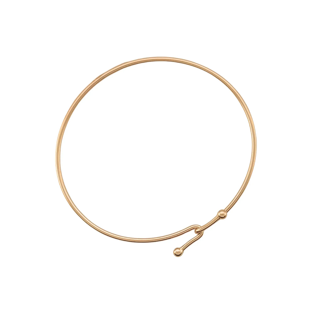 Gold wire necklace on a white background