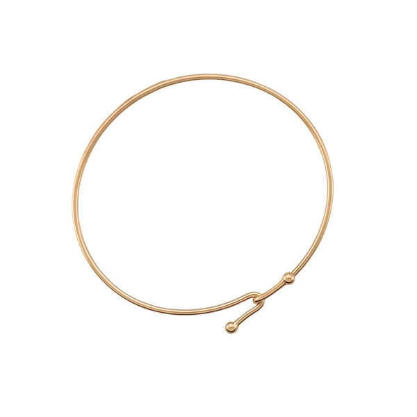 Gold wire necklace on a white background