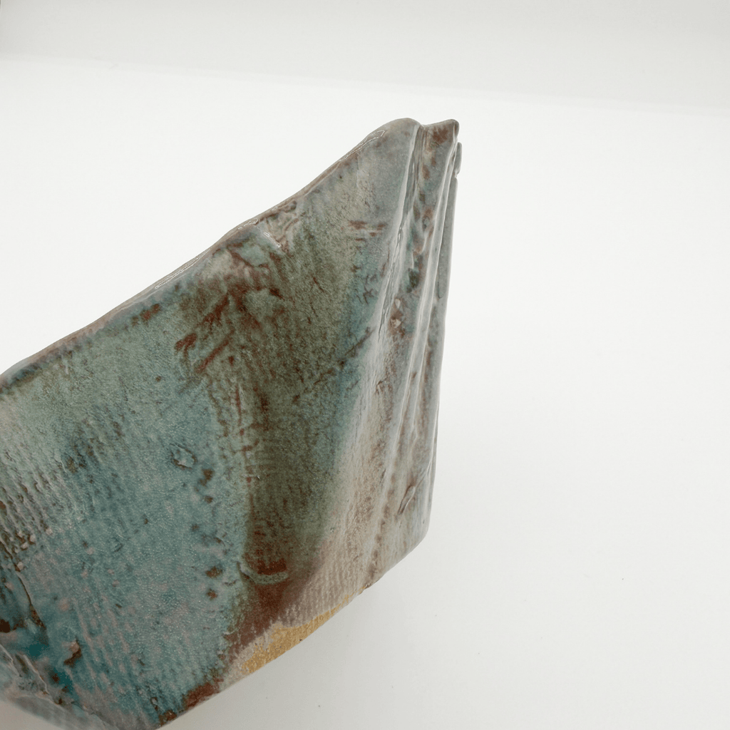 Close-up of a textured ceramic object on a white background