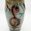 Ceramic vase with abstract multicolored design on a white background