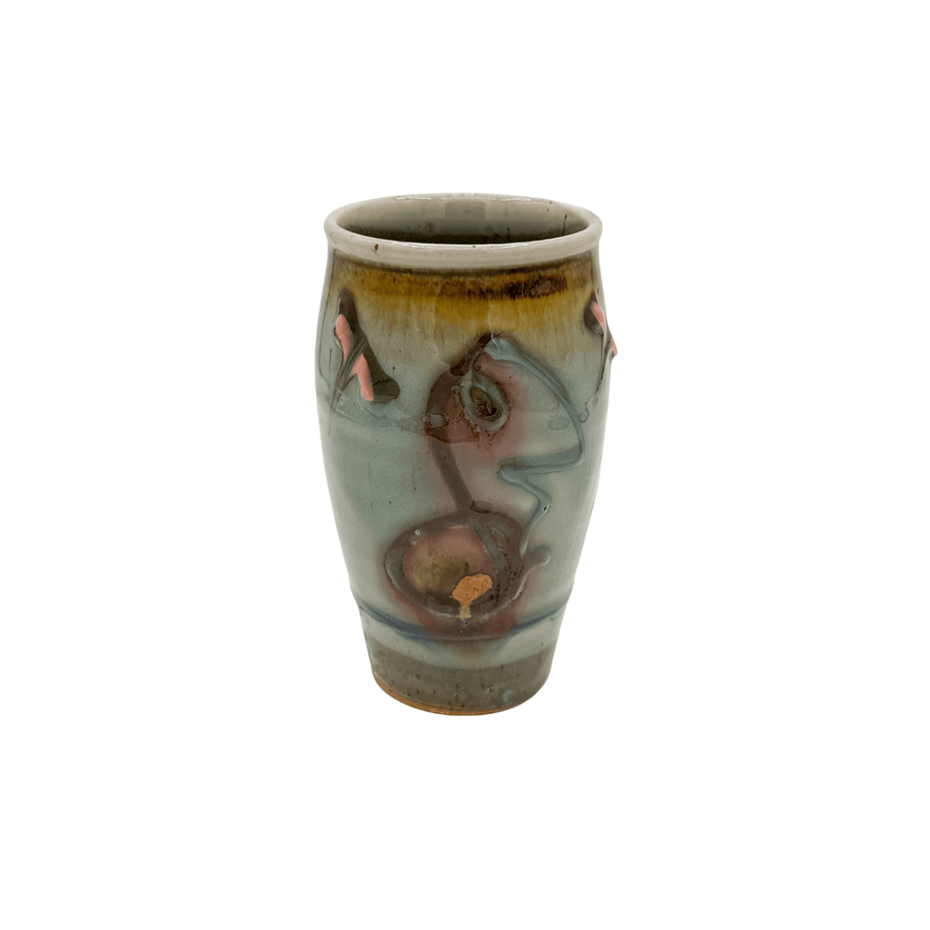 Ceramic vase with artistic design on a white background