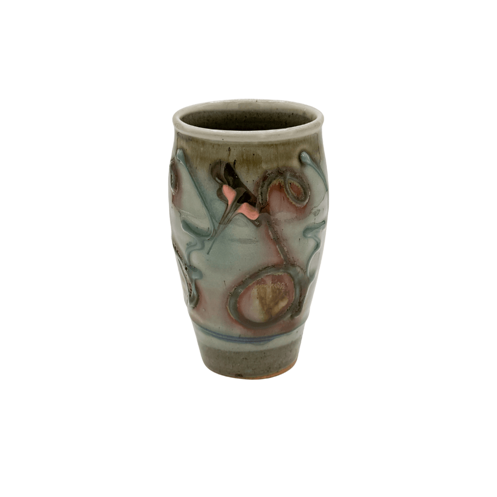 Ceramic cup with artistic design on a white background