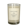 Candle in a clear glass jar with a label on a white background
