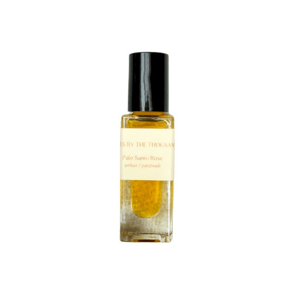 Small glass bottle with a black cap on a white background