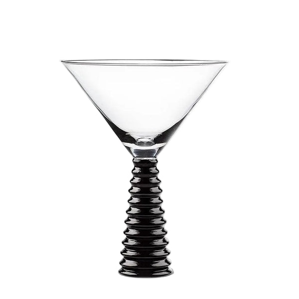 Cocktail glass with black ribbed stem on a white background
