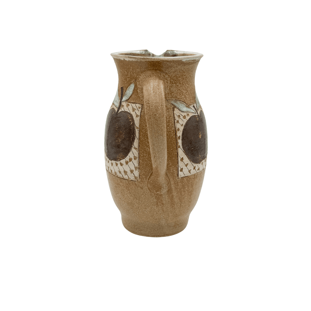 Ceramic pitcher with decorative elements on a white background