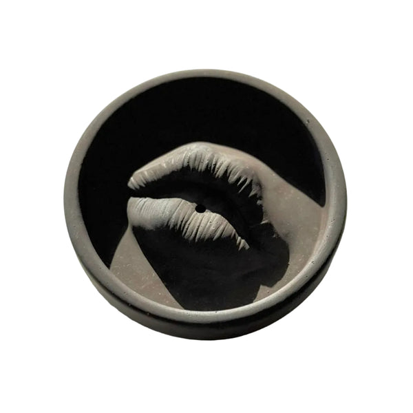 Ceramic cup with a design of lips on a white background