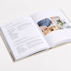 Open book with text and a photo on a white background