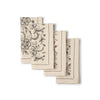 Set of four beige napkins with black floral patterns on a white background