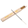 A boxed incense stick set labeled BARE LAIT, shown with a long incense stick laid diagonally across the open package on a light warm beige background.