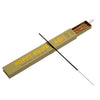 A long incense stick rests diagonally across an open rectangular box labeled 'POPPY POIRE' in gold lettering on a muted olive-green background. The incense stick is black with a silver tip, and several brown incense sticks are visible inside the box against a pale cream backdrop.
