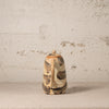 Ceramic pitcher with brown and beige patterns on a textured surface and background