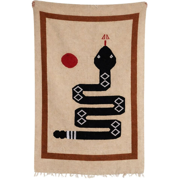 blanket textile  with a black snake design on a beige background