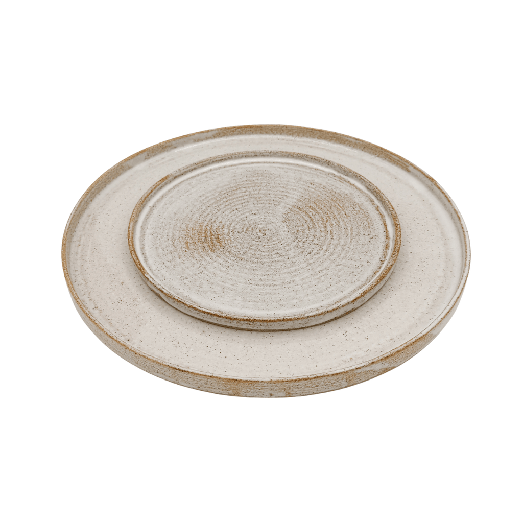 Set of two ceramic plates with textured surface on a white background