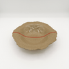 Ceramic plate with a textured surface and red accent on a white background