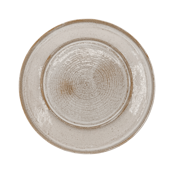 Round ceramic plate with textured surface on a white background