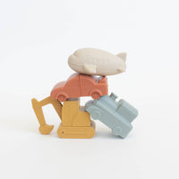 Set of colorful toy blocks shaped like a car, person, and suitcase on a white background