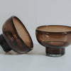 Two brown glass bowls on a white background