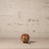 Small decorative armadillo with intricate designs on a textured surface