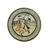 Decorative plate with a traditional design of two figures and a dog on a white background