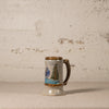 Ceramic mug with decorative elements on a textured surface