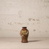 Decorative vase with floral patterns on a textured surface