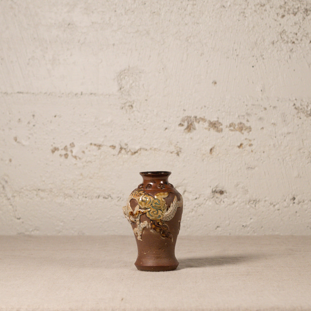 Decorative vase with floral patterns on a textured surface