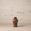 Decorative vase with floral patterns on a textured surface