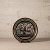 Decorative plate with animal design on a textured surface