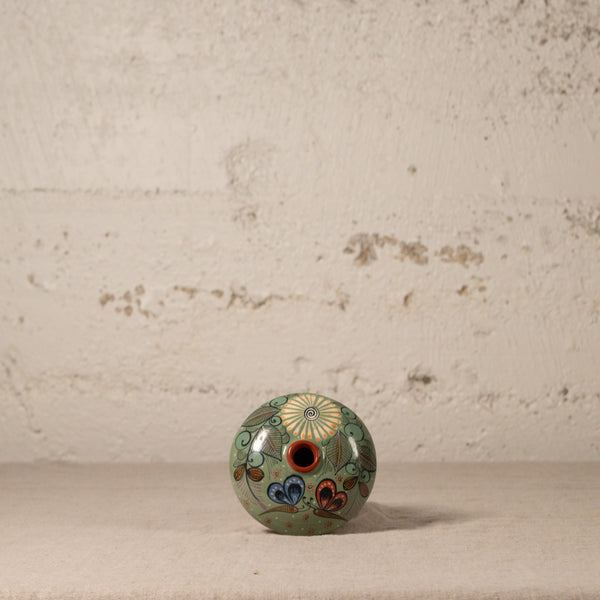 Decorative ceramic vase with floral patterns on a textured surface