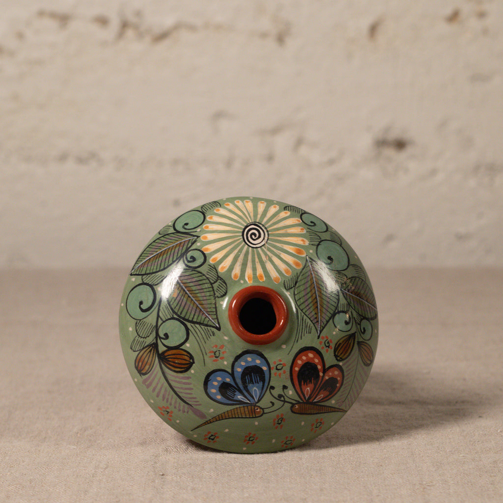 Decorative ceramic vase with floral patterns on a neutral background