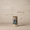 Small ceramic vase with decorative design on a textured surface and background